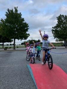 Smiling child learning to ride a bike